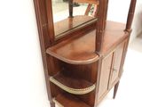 a corner cabinet with a mirror on top of it