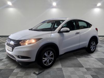 a white honda hrx parked in a garage with a checkered floor