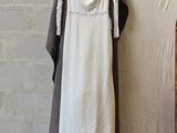 a picture of a white dress hanging on a clothes rack