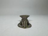 brass plate with a hand holding a flower on top of it