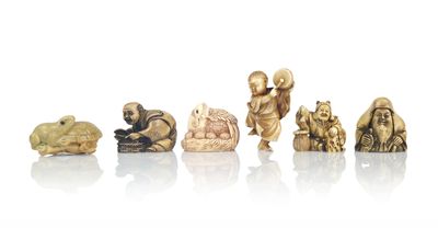 an image of a group of carved figurines on a white surface
