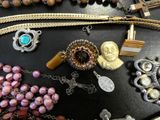 many different types of necklaces on a table