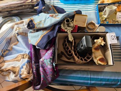 une boîte remplie d'objets posée sur un lit recouvert d'une couverture bleue et blanche
