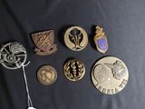 a lot of badges that are on a black surface