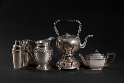 an image of a silver tea set with a teapot and cups