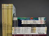 many books stacked on top of each other on a table