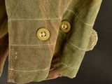 close up of a man ' s shirt with buttons on a dark background