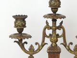 three candles that are on a stand on a table