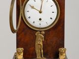 a clock that is sitting on a wooden table