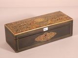 an old wooden box with a decorative design on the lid