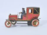 a red toy car with a man sitting in it