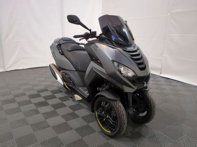 a picture of a motor scooter parked on a checkered floor