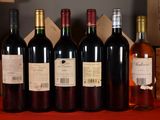 several bottles of wine are lined up on a table