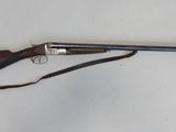 an old gun with a wooden handle and a leather strap