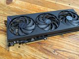 a close up of a video card sitting on top of a wooden table