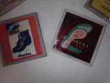 two magnets that are on a table with a picture of a shoe
