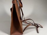 the small brown bag is sitting on a white surface