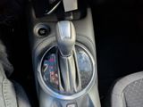 a close up of a car ' s gear knob with a cell phone in it