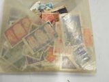 a clear bag with stamps inside of it on a table