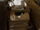 Plusieurs cartons de nourriture sont empilés les uns sur les autres dans une pièce