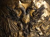 an image of a gold plate with a bird on it