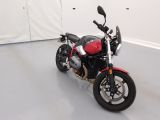 a red and black motorcycle parked in a white room