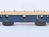 three toy trains sitting side by side on a white surface