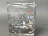 a shot glass with a picture of a flower pot on it