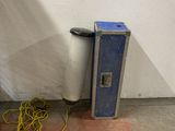 a blue case sitting next to a white wall with a yellow cord