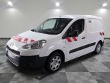 the white van is parked on a checkered floor in the garage