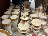 many cups and saucers sitting on a table