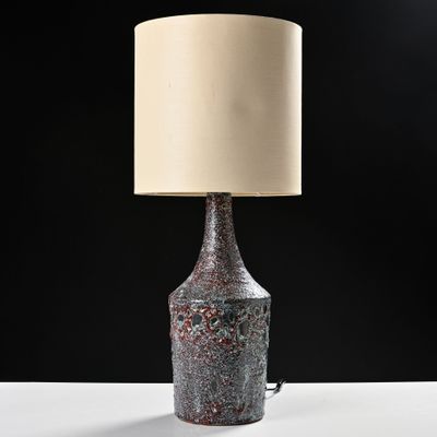 a close up of a lamp on a table with a black background