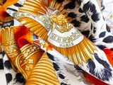 a close up of a scarf with a gold eagle on it