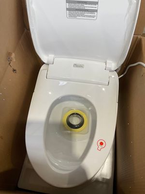 a toilet that is sitting in a box with the lid up
