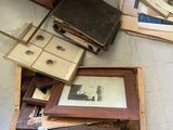 a pile of old books on the floor next to a wooden box