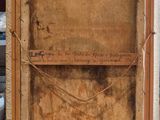an old picture of a person holding a piece of wood with writing on it