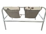 pair of brown and white chairs sitting on top of a metal frame