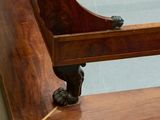 a wooden bench that has a clock on top of it