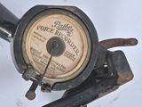 a close up of a gauge on the side of a pole