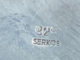 a close up of a silver plate on a table