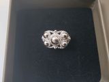 a silver ring in a black box on a table