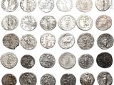 a close up of a bunch of silver coins on a white surface