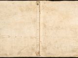 an old book is open on a black surface