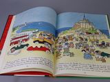 an open book with a picture of a city on it