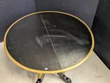 an image of a black and gold table with wheels on it