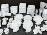 a lot of white figurines sitting on a table
