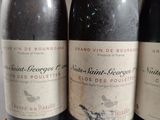 three bottles of wine sitting on top of a table next to each other