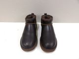 a close up of a pair of black boots on a white surface