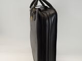 the black briefcase is sitting on a white surface