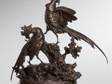 an image of a bronze sculpture of two birds on a tree stump